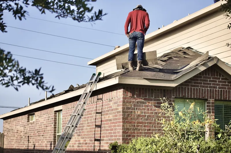 Professional roofer working on a residential roof in Albury Manor